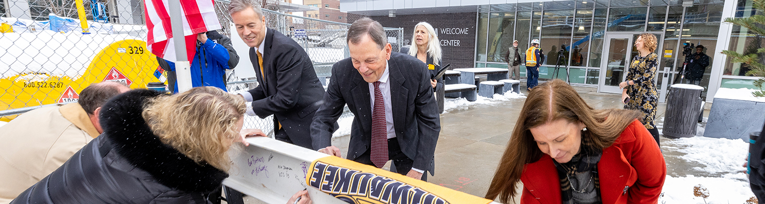 UWM Administrators signing the final beam to be placed in the new Chemistry Building