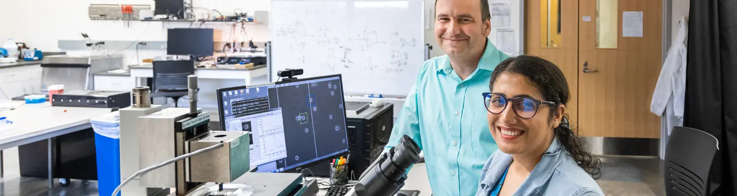 two people in lab with equipment around
