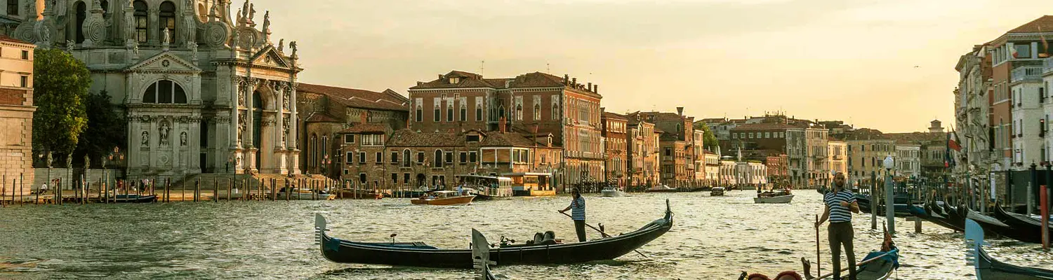gondolas on river between buildings