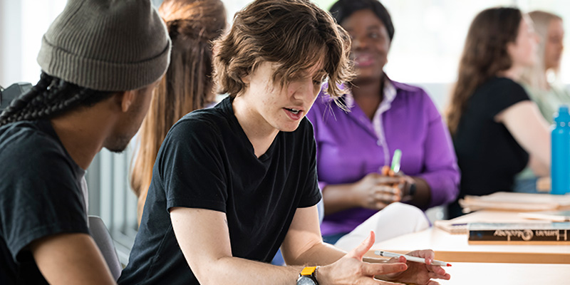 Students in conversation together in a classroom