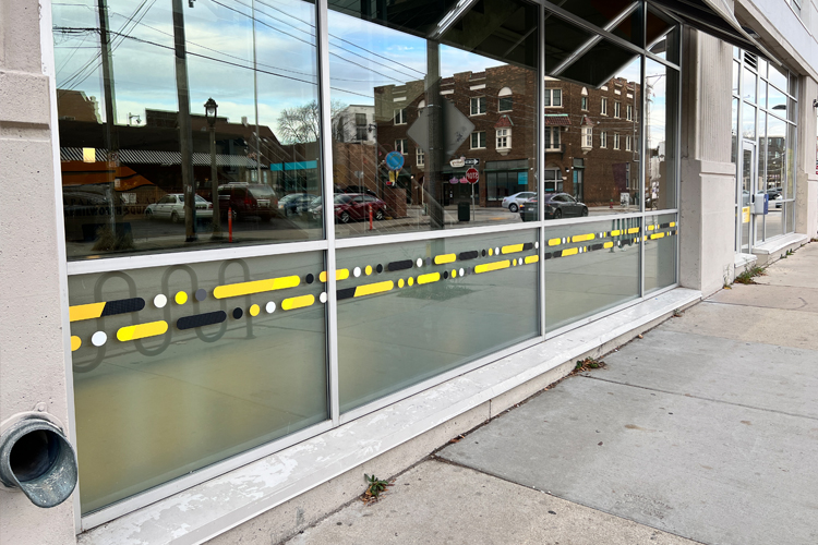 Kenilworth Square Apartment exterior windows with cut vinyl window graphics