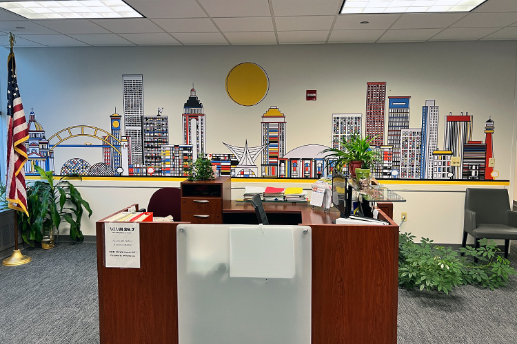 The lobby mural features a Milwaukee skyline created from printed vinyl, contour cut, and applied to the wall.