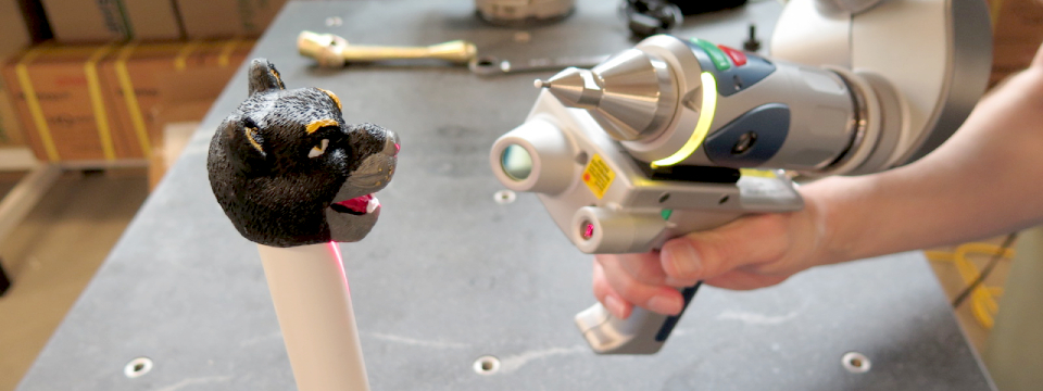 A laser scanner is used to capture the three dimensional surface of objects for digital manipulation and inspection. Here a sculpt of the UWM mascot, Pounce, is being scanned.