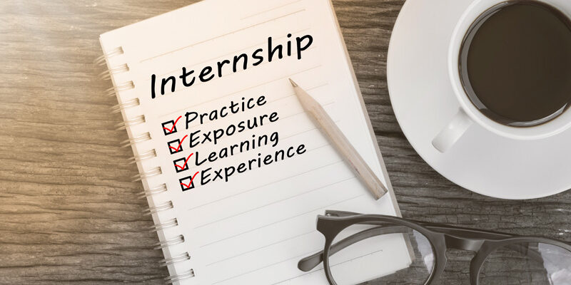 Notebook and coffee—notebook lists practice, exposure, learning, and experience under Internship heading