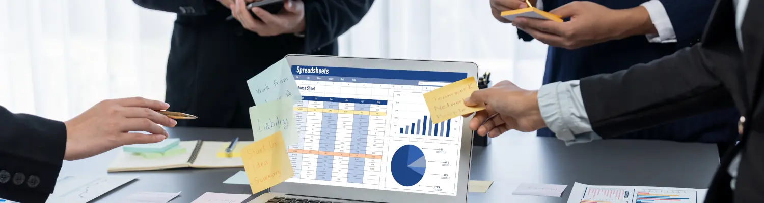 people looking at information on a laptop monitor