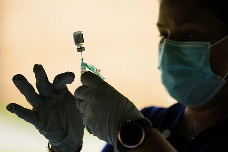 Health care worker preparing vaccine.