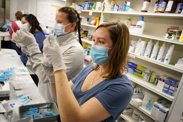 Pharmacy employees prepare vaccines