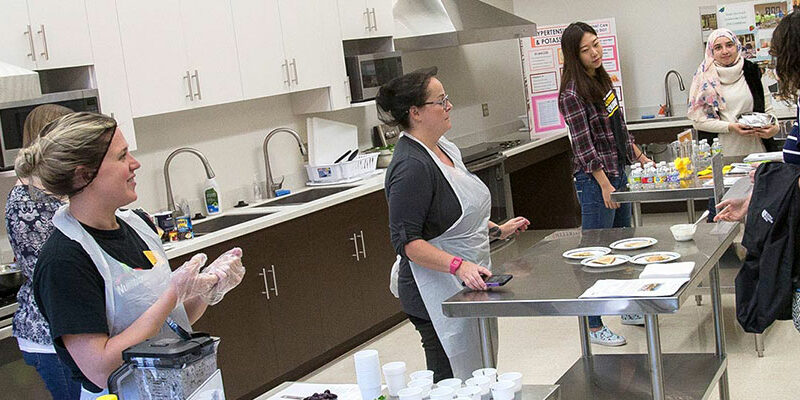Students in nutritional science course working in a kitchen