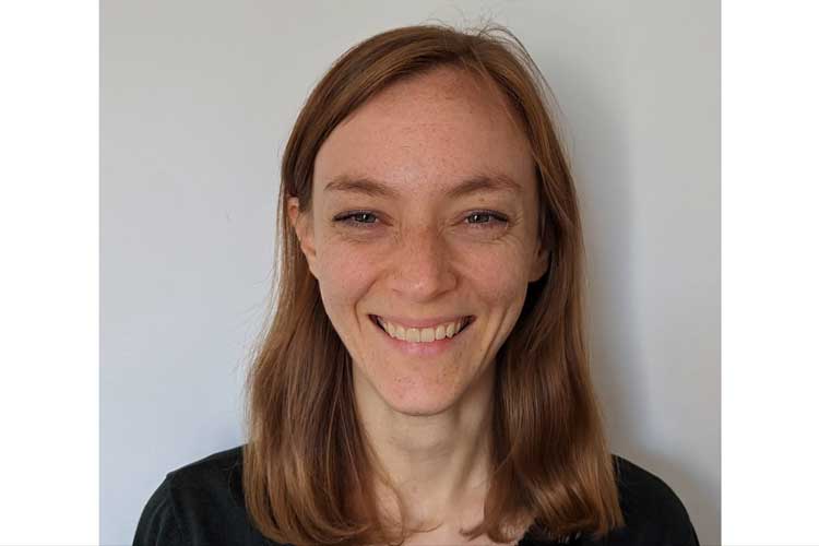 White woman with blond hair smiling.