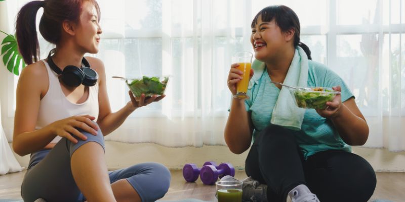 two women after workout eating healthy foods