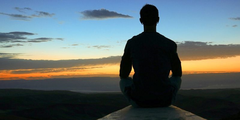 meditation man looking at sunrise