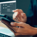 Close-up of a person's hands holding a smart phone and communicating with an AI chatbot.