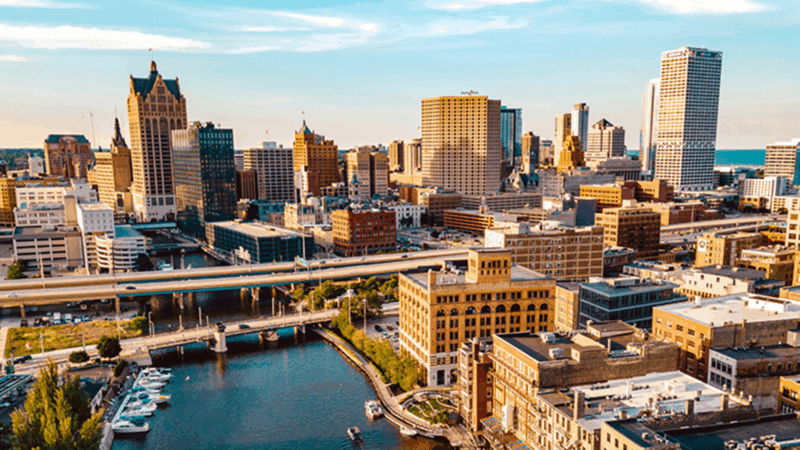 A birds-eye view of the city Milwaukee and the Milwaukee River running through downtown.