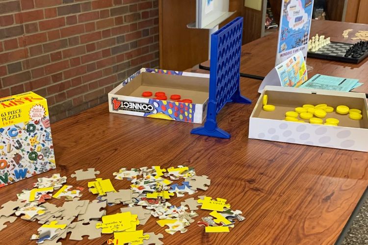 games on table: puzzle, connect 4, chess and Bananagrams