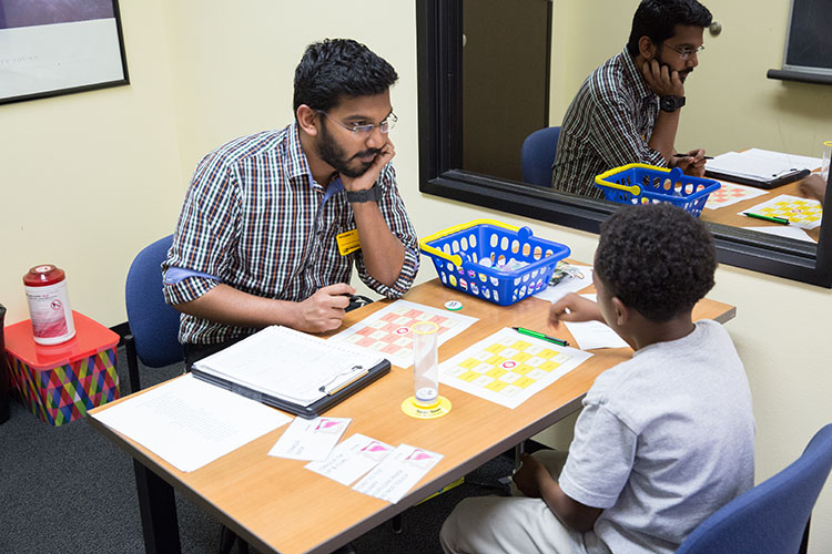 Student working with a child on speech