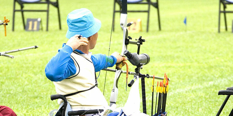 Three archers shooting from a wheelchair for therapeutic recreation