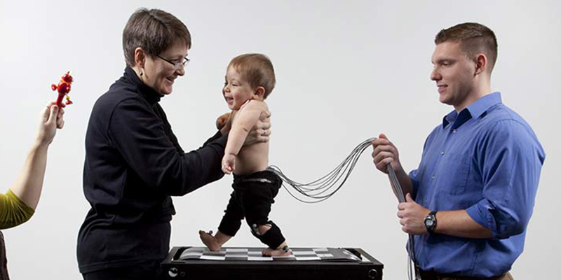 Baby being tested by researchers in the Pediatric Neuromotor Lab
