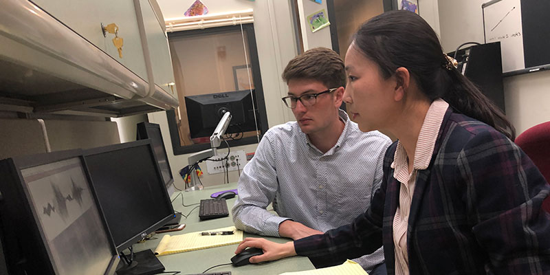 Professor Yang with a student in the Speech Acoustics & Development Lab