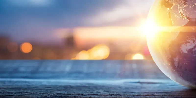 globe on table with sunrise/sunset in background