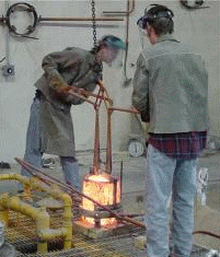 Removing crucible from furnace and pouring metal into mold