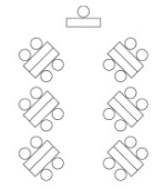 Herringbone Room Configuration with groups of two table back-to-back and four chairs angled so one side of the tables faces the presenter at the front. This configuration is good for grouping participants into groups of four.