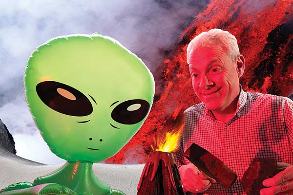 Professor next to volcano and alien