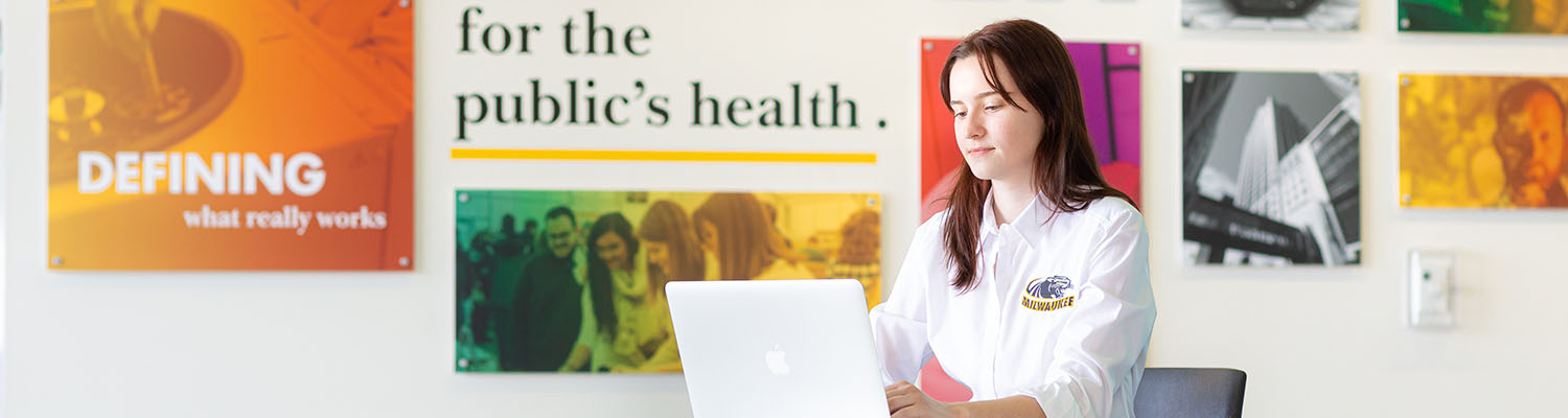 Public health student working on a laptop