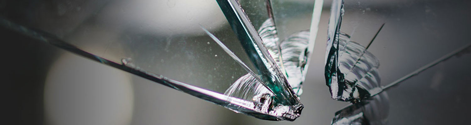 Close up shot of broken glass hit by a bullet or projectile