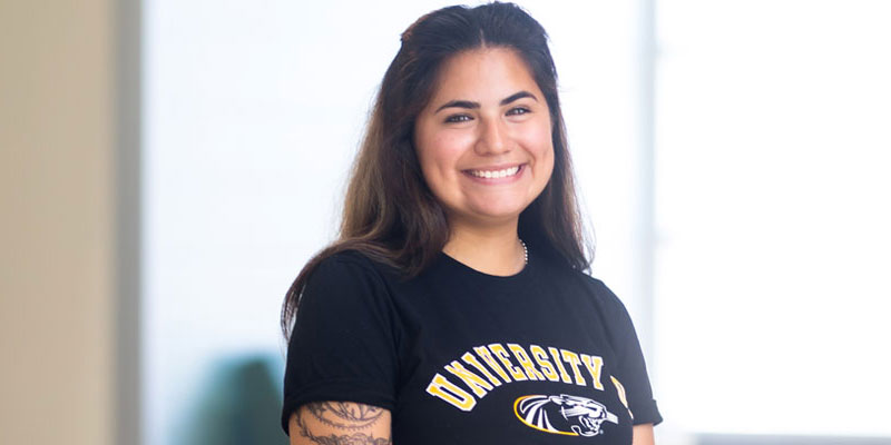 Portrait of Leslie Torres (Latina woman), a criminal justice student wearing a black UWM tee-shirt.