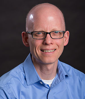 Photo of Eric Gresnick (white man), director of shared office for administration of research