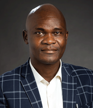 PhD student Ebenezer Adegoke Omotosho wearing suit jacket.