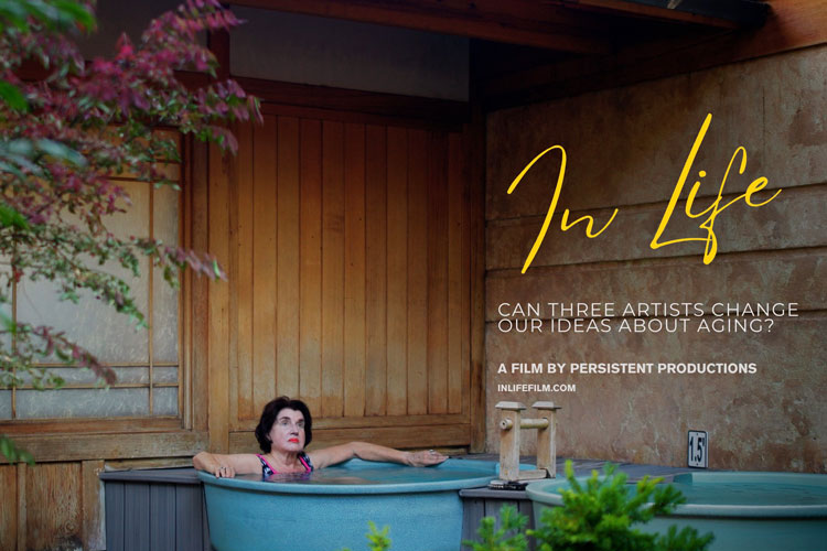 Older adult female relaxing in a Japanese swimming pool with a wood paneled wall behind her.