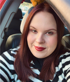 Headshot of Emma Lannerd wearing a striped shirt.