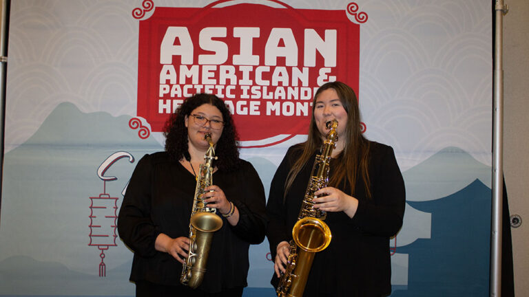 Two students playing instruments for AAPI celebration
