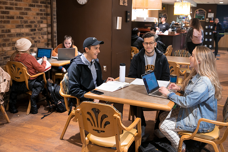 Students studying and talking with each other at the Grind coffee shop in the UWM Student Union