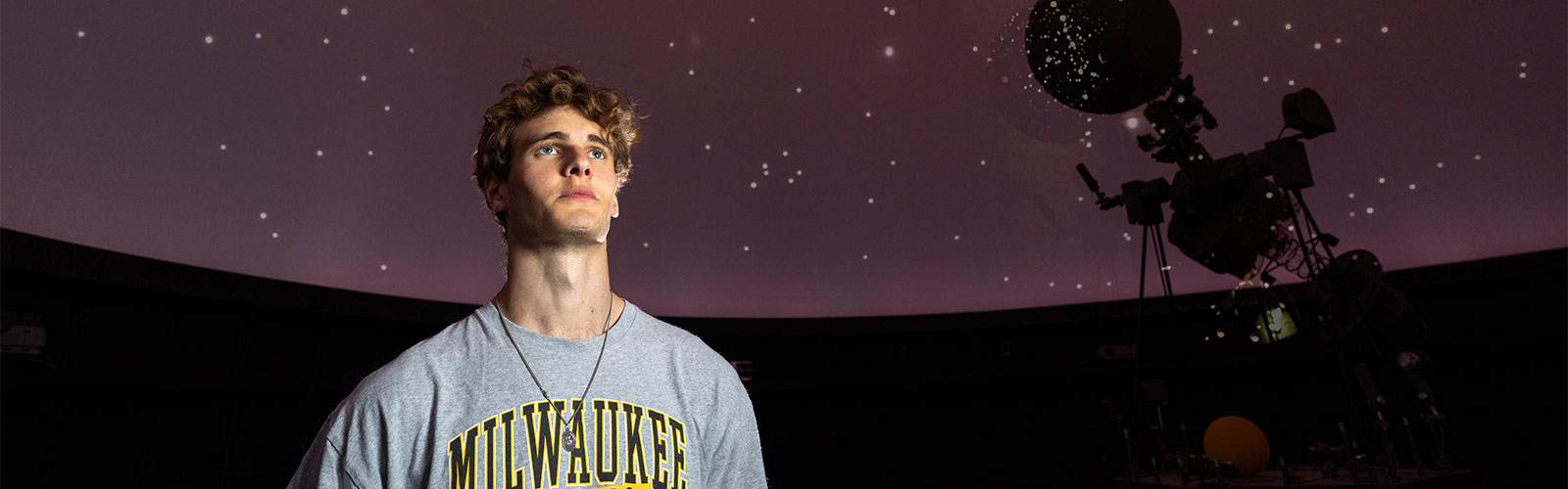 UWM student in the UWM planetarium during a star show. Showcasing UWM Preview Days