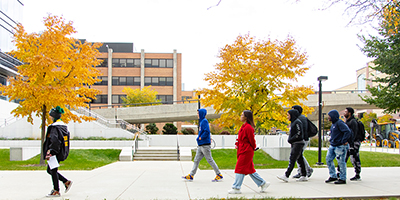A campus ambassador leads a group of student on a tour of UWM.