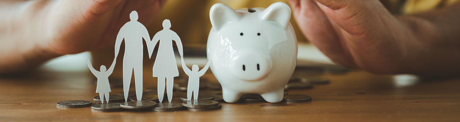 piggy bank with paper cutout family nearby