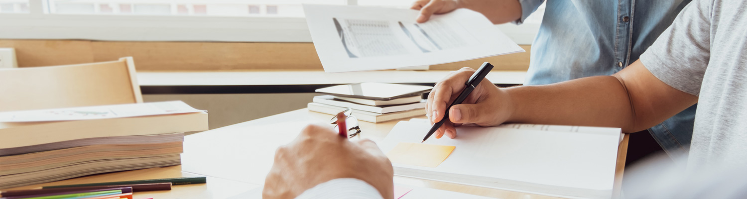 hands writing something on paper