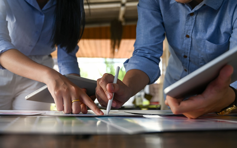 closeup for hands pointing to papers