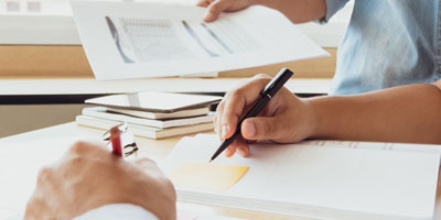 closeup of hands doing paperwork