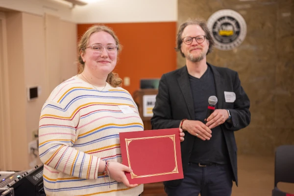 Caitlin Monahan holding award