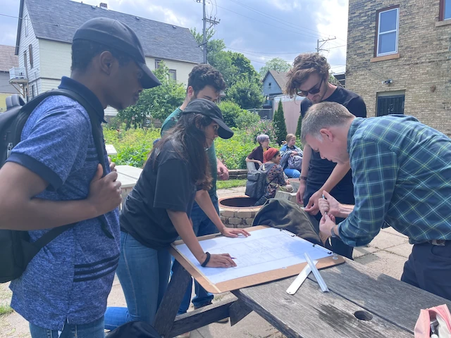 A group of people working at a table doing field study
