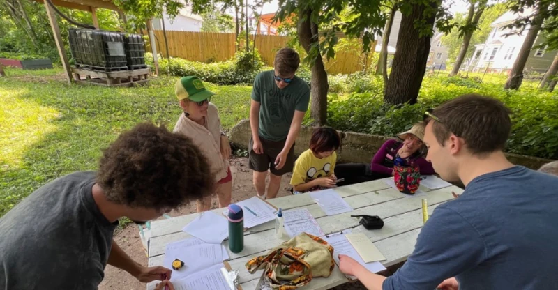 A group of people working at a table doing field study
