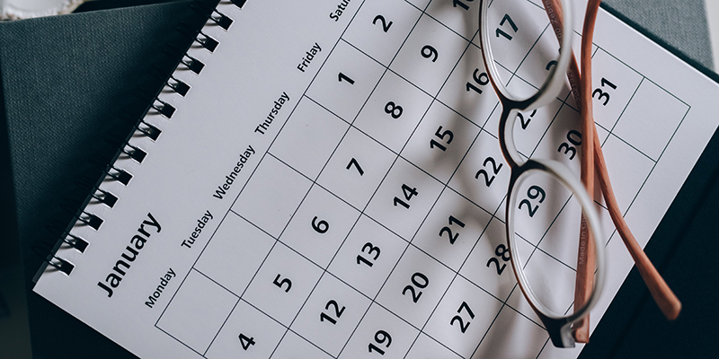 A photo of a calendar with a pair of glasses on top