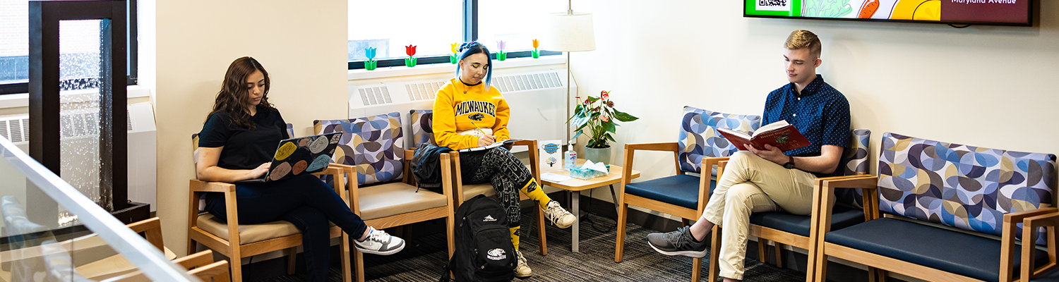 Three UWM students sit in the 8th floor waiting area at the Student Health and Wellness Center.