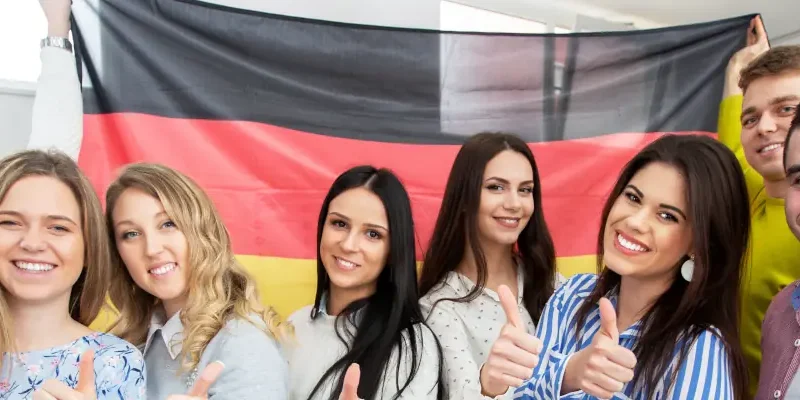 students posing in front of German flag