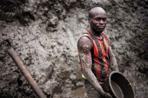 dirty person working in a coltan mine