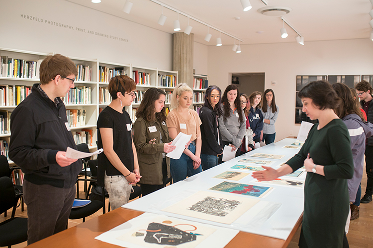 Faculty member instructs students at the prints studeio at the Milwaukee Art Museum