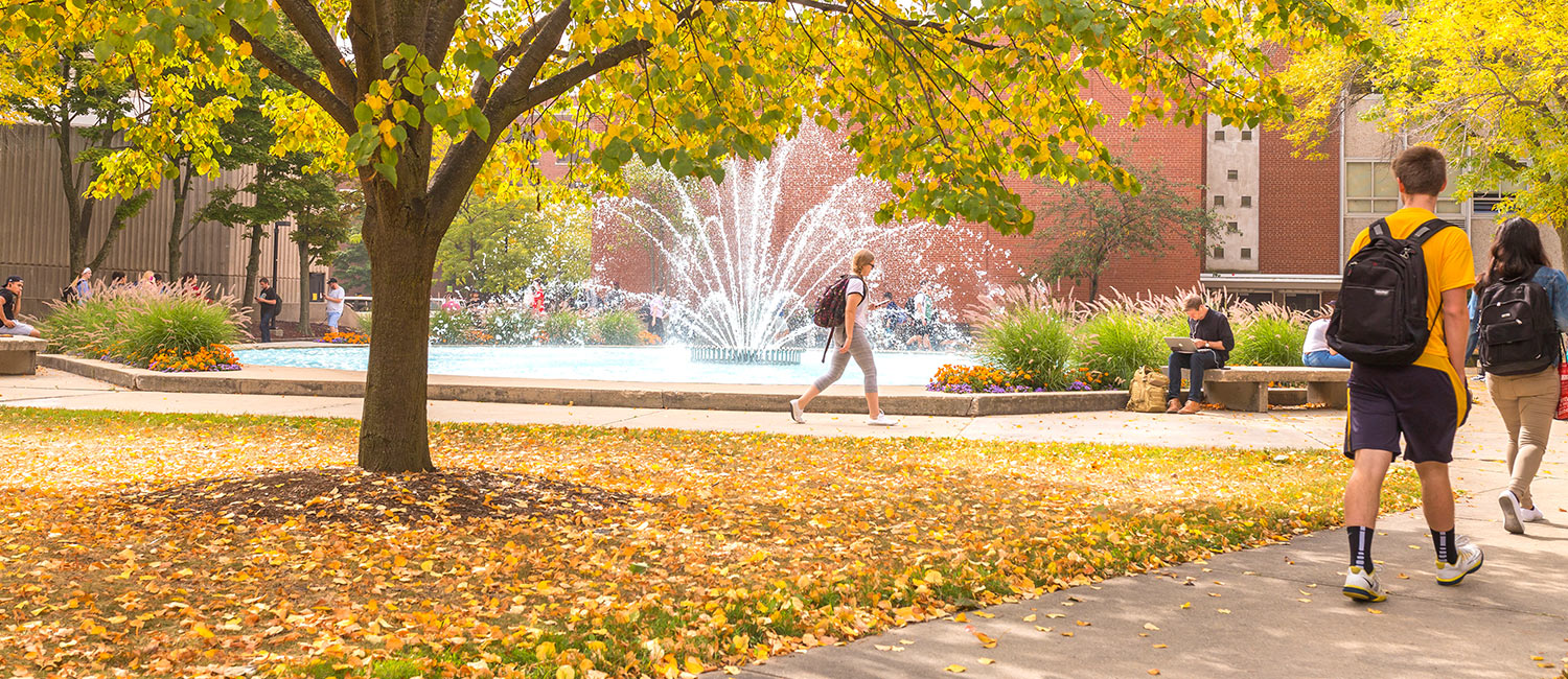 Students walking around campus near the UWM fountain